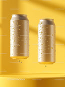Two Cold Alcohol-Free Beverage Cans with Condensation on Yellow Background