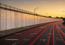 Urban Highway with Light Trails at Sunset