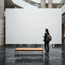 Woman Standing in Modern Gallery with Blank Wall