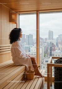 Woman Relaxing in Sauna with Cityscape View in Modern Wellness Center