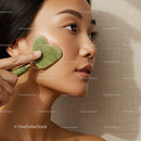 Portrait of a Woman Using Jade Roller for Facial Massage and Skin Rejuvenation