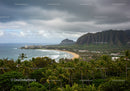 Lush Green Mountain Range and Sandy Beach with Stormy Sky