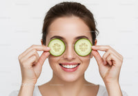 Smiling Woman with Cucumber Slices Over Eyes for Refreshing Skin Care