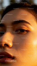 Close up of woman’s face glowing in warm light