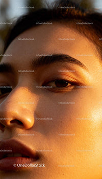 Close up of woman’s face glowing in warm light