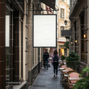 Blank signboard on charming narrow city street cafe