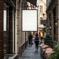 Blank signboard on charming narrow city street cafe