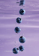 Fresh blueberries submerged in clear lavender water