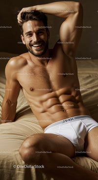 Smiling muscular man reclining on bed in white underwear