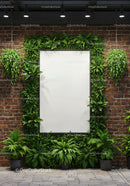 Modern brick wall with green plants and blank frame
