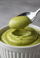 Creamy green avocado mousse in white ramekin with spoon