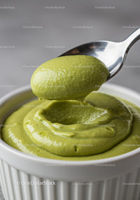 Creamy green avocado mousse in white ramekin with spoon