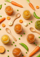 Fresh vegetable purees with carrots and peas on beige