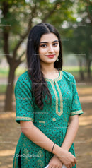 Young Woman in Elegant Green Traditional Dress Standing in Park Outdoors