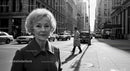 Elderly Woman Walking in City Street in Professional Attire