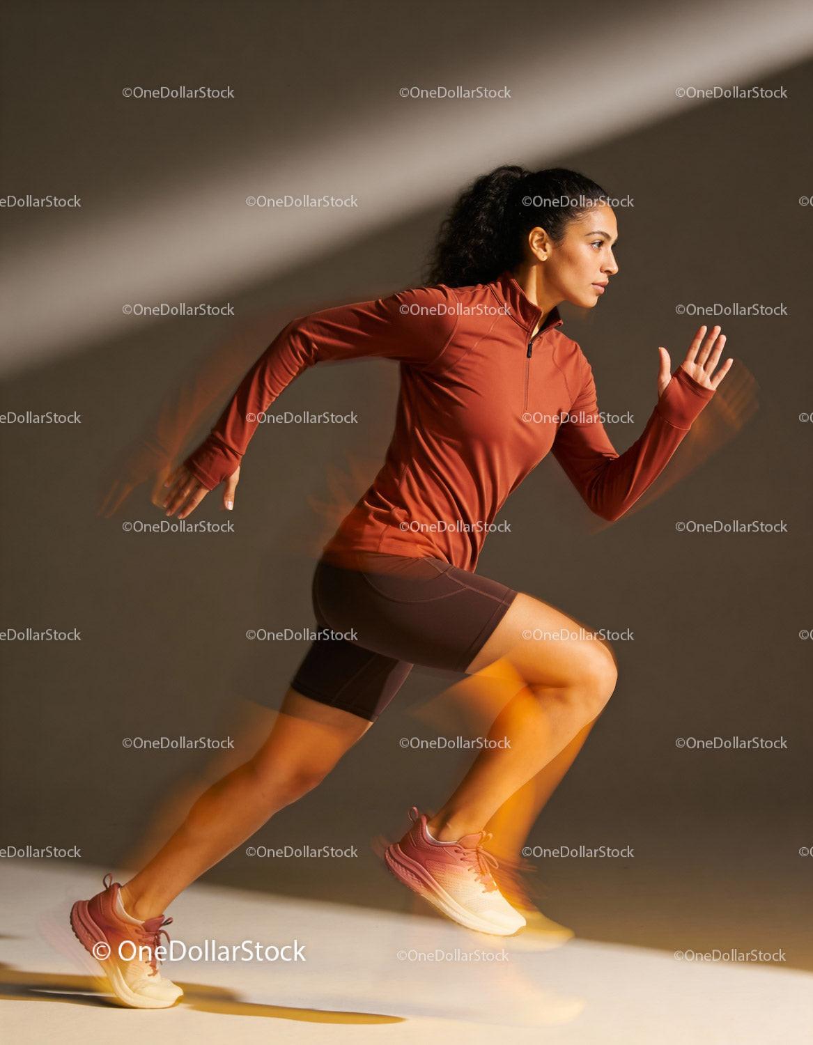 Athletic woman sprinting indoors with dynamic motion blur