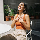 Joyful Woman Laughing in a Bright Outdoor Setting