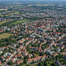 Aerial View of Historic and Modern City with Red Roofs and Green Parks