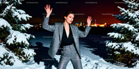 Woman in patterned suit posing outdoors on snowy night