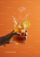 Refreshing iced tea splash with lemon slice in hand