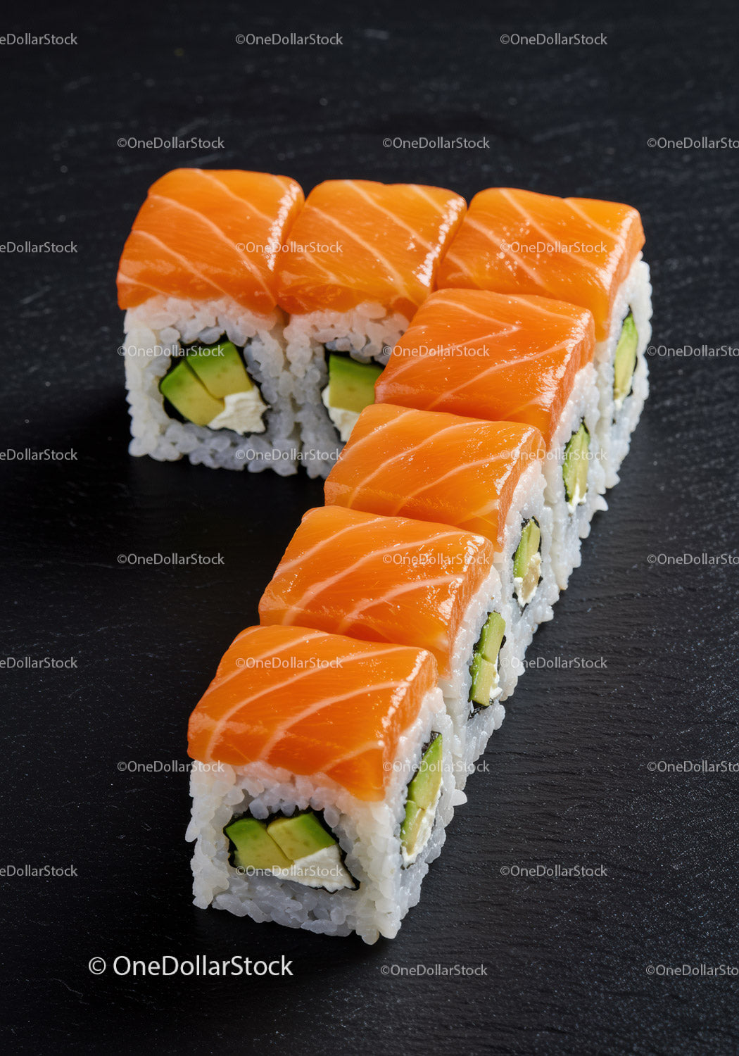 Fresh salmon sushi rolls arranged in number seven shape