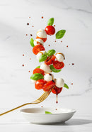 Fresh Caprese Salad Ingredients Levitating Over Plate