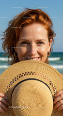 Smiling Woman with Red Hair Holding Straw Hat on Beach Scene