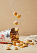 Mini Pancakes Falling from Open Canister on Table