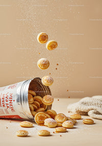 Mini Pancakes Falling from Open Canister on Table