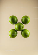 Arrangement of Fresh Green Limes on Neutral Background