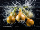 Fresh Green and Yellow Onions Splashing in Water