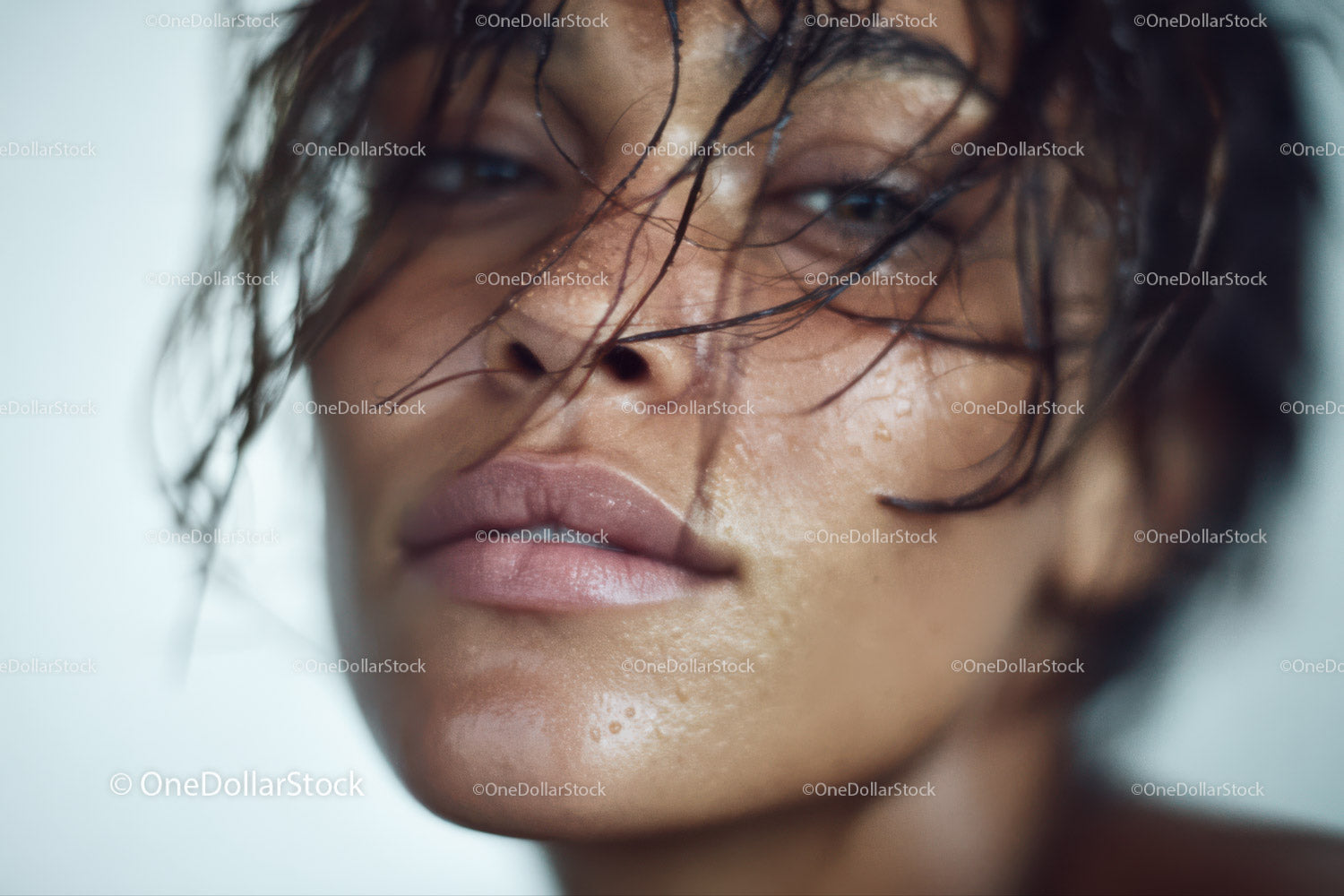 Close-up of Water-Drenched Woman with Wet Hair and Soft Expression