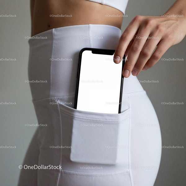 Woman placing smartphone into white workout leggings pocket JPG Mockup Image