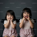 Two Happy Girls with Joyful Expressions Sitting Together
