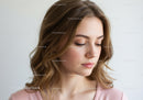 Portrait of a Young Woman with Wavy Brown Hair and Soft Expression