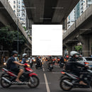 Busy urban street with motorbikes under concrete overpass
