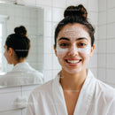 Smiling young woman enjoying facial skincare routine