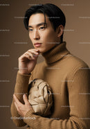 Stylish Young Man in Beige Turtleneck Holding a Modern Art Ball