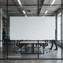 Modern office meeting room with glass walls and blank board