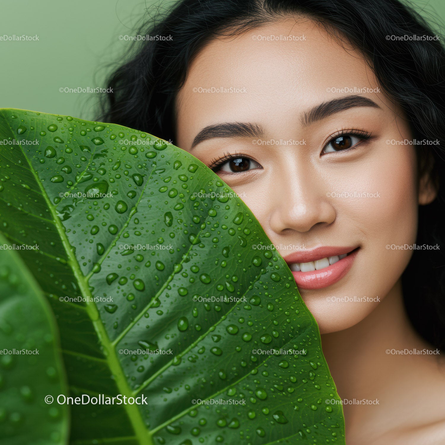 Beautiful Woman with Green Leaf and Water Droplets Close-up