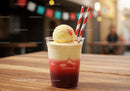 Refreshing Strawberry Ice Cream Sundae in Plastic Cup with Striped Straws