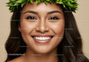 Smiling young woman with green leaf crown and glowing skin