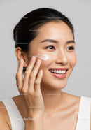 Happy Woman Applying Skincare with Bright, Smooth Skin