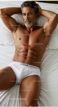 Mature man relaxing on bed in white underwear