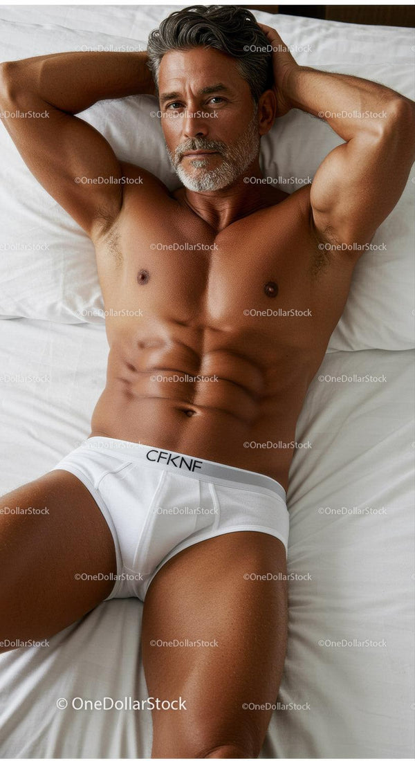 Mature man relaxing on bed in white underwear