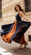 Woman in flowing black and rust maxi dress on street