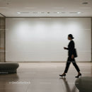 Businesswoman walking past blank gallery wall