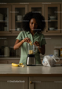 Young Woman Preparing Banana Smoothie in Modern Kitchen