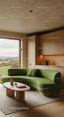 Cozy living room with curved green sofa and natural light