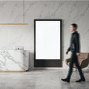 Modern marble reception area with blank digital display